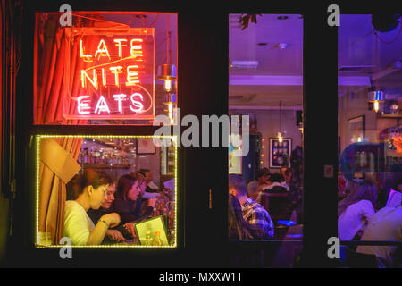 London, UK - October 2017. People drinking cocktails in a club in Soho. Landscape format. Stock Photo