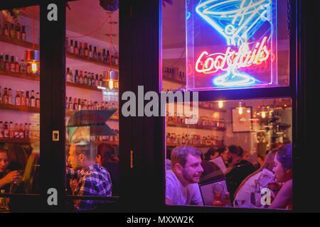 London, UK - October 2017. People drinking cocktails in a club in Soho. Landscape format. Stock Photo