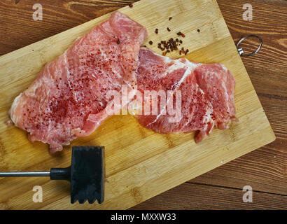 Raw cut meat on a wooden board. Pork chunks for chops , cooking pork chop, Stock Photo