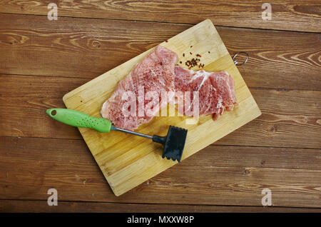 Raw cut meat on a wooden board. Pork chunks for chops , cooking pork chop, Stock Photo