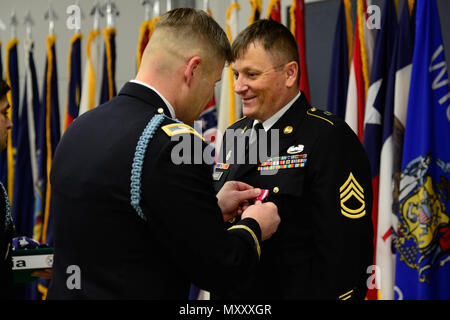 U.S. Army Col. Lance Varney, Commander of the U.S. Army Garrison (USAG) Bavaria, recognizes Sgt. 1st Class James Rigdon, assigned to Bravo Company, Allied Forces North Battalion, for his time in service during the USAG Quarterly Military Retirement Ceremony, in Vilseck, Germany, Dec. 9, 2016. (U.S. Army photo by Spc. Emily Houdershieldt) Stock Photo