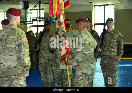 Sgt. 1st Class Dwayne T. Cottoner, center, passes the flag to Command Sgt. Maj. Todd M. Burke, right, outgoing command, during a change of responsibility ceremony for 173rd Brigade Support Battalion,173rd Airborne Brigade  at  Caserma Del Din in Vicenza, Italy, Dec. 13, 2016.  The 173rd Airborne Brigade based in Vicenza, Italy, is the Army Contingency Response Force in Europe, and is capable of projecting forces to conduct the full of range of military operations across the United State European, Central and Africa Commands areas of responsibility. (U.S. Army photo by Visual Information Specia Stock Photo
