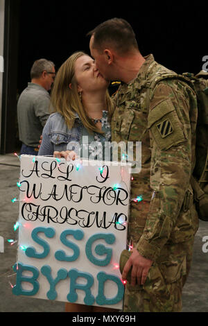 A Soldier of 6th Squadron, 8th Cavalry Regiment, 2nd Infantry Brigade Combat Team, 3rd Infantry Division reunites with a loved one at Fort Stewart, Georgia, December 13, 2016. Troopers of 6-8 Cav. returned from a five-month rotation supporting Joint Multinational Training Group-Ukraine, building sustainable training capacity and capability within Ukrainian land forces. (U.S. Army photo by Staff Sgt. Candace Mundt/Released)