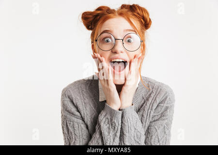 Portrait of an excited young school nerd girl looking at camera isolated over white background Stock Photo