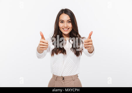 Portrait of a smiling asian businesswoman showing thumbs up isolated over white background Stock Photo