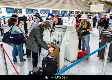 Mexico City,Mexican,Hispanic,Benito Juárez International Airport MEX,terminal,interior inside,self check-in kiosk,woman female women,man men male,pass Stock Photo