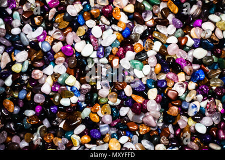 Group of many different natural gemstones. Collection of small colored semiprecious gemstones amethyst, lapis lazuli, rose quartz, citrine, ruby, amaz Stock Photo