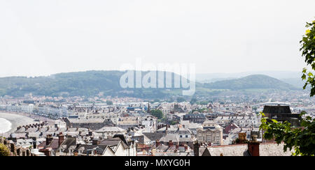 City of Llandudno in North Wales, United Kingdom. Traditional UK cityscape from the hilltop. Town aerial view over busy main street and houses. Photo  Stock Photo
