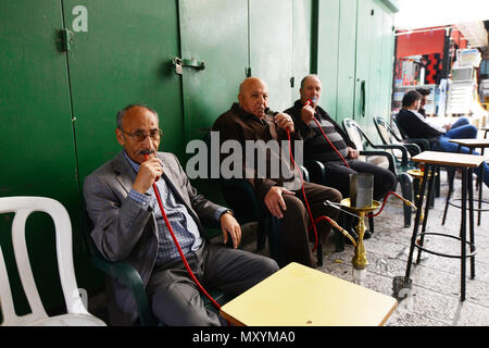 Palestinian men smoking Nargila in the old city of Jerusalem. Stock Photo