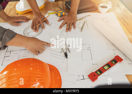 Architect or engineer working on blueprint, architectural concept. Engineer discussing with Architect team meeting and discussing project plan.Enginee Stock Photo