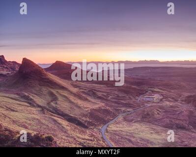 Quiraing mountains sunset at Isle of Skye, Scottish highlands. Tourist hiking around  romantic green valley Stock Photo