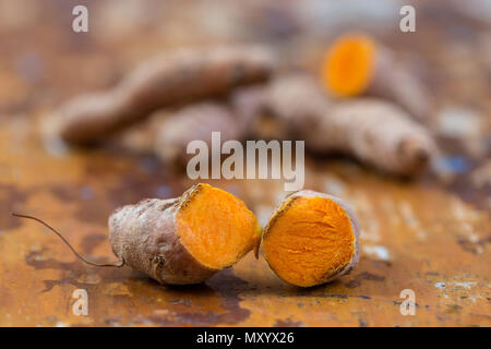 Turmeric curcuma . Indian oriental spice roots on wooden table Stock Photo
