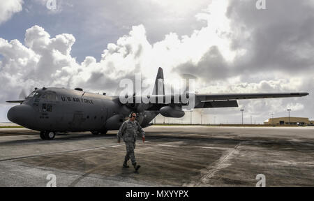 Master Sgt. Christopher Mace, 374th Aircraft Maintenance Squadron crew chief, prepares to marshal a C-130H Hercules assigned to the 36th Airlift Squadron during Operation Christmas Drop 2016 at Andersen Air Force Base, Guam, Dec. 7, 2016. Operation Christmas Drop is a joint-training operation between the U.S. Air Force, the Royal Australian Air Force and the Japanese Air Self Defense Force wherein C-130 air crews deliver bundles of donated supplies to the Micronesian Islands. This year is the 65th anniversary of OCD, making it the longest running humanitarian mission in the world. (U.S. Air Fo Stock Photo