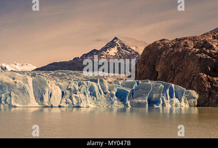 Landscape of the Grey Glacier and Lago Grey with the Andes mountain range in the background. A photograph edit appealing the nostalgia of Patagonia. Stock Photo