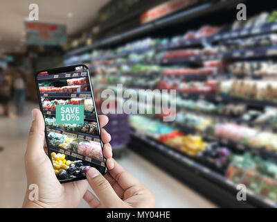 Family in the supermarket use Application of Augmented Reality Supermarket for Discounted or on Sale Stock Photo