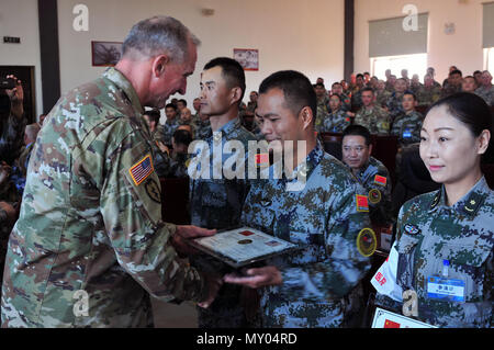 Gen Robert. B. Brown, Commanding General U.S Army Pacific, recognizes several People’s Liberation Army participant’s whose performance was exceptional as part of the closing ceremony of the 12th US-China Disaster Management Exchange, November 19, Kunming, Yunnan province, People’s Republic of China. The annual United States Army Pacific (USARPAC) Security Cooperation event with the People’s Liberation Army (PLA) is an opportunity to share Humanitarian Assistance/Disaster Relief lessons learned from real world events and enhance U.S. and Chinese disaster management capabilities. (U.S. Army phot Stock Photo