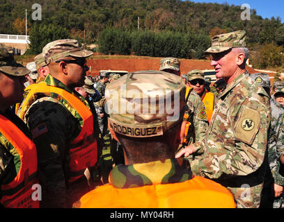 Gen. Robert. B. Brown, Commanding General U.S Army Pacific, visits Soldiers from the 130th Engineer Brigade, 8th Theater Sustainment command at the River crossing event during the 12th US-China Disaster Management Exchange, November 18, Kunming, Yunnan province, People’s Republic of China. U.S Army and People’s Liberation Army Engineers constructed a bridge over a river to evacuate civilians stranded on an island as part of a fictional earthquake scenario in which the two armies’ were responding to as part of the recovery efforts. The annual United States Army Pacific (USARPAC) Security Cooper Stock Photo