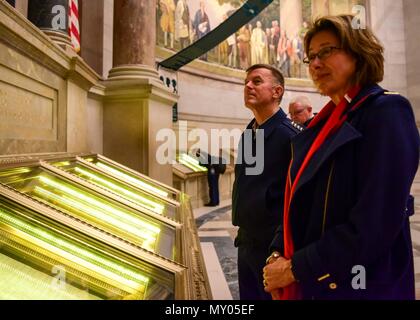 U.S. Coast Guard Commandant Adm. Paul Zukunft and his wife, Fran DeNinno-Zukunft, take a tour of the National Archives in Washington, D.C., Dec. 30, 2016. The Zukunfts looked over the Declaration of Independence, United States Constitution and the Bill of Rights in the National Archives Rotunda. (U.S. Coast Guard photo by Petty Officer 2nd Class Diana Honings/released) Stock Photo