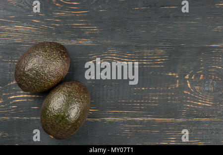 Two ripe avocados Hass on an empty wooden background top view Stock Photo