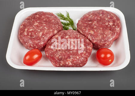 beef burgers in plastic package isolated on white background Stock Photo
