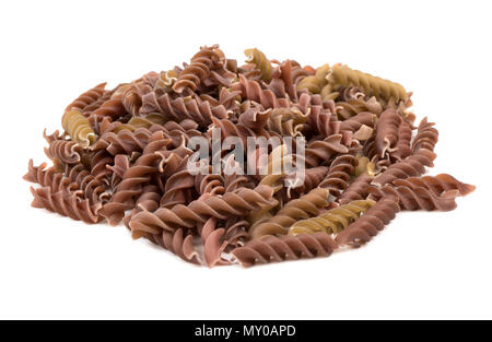 Small dark pile of pasta fusilli on white background Stock Photo