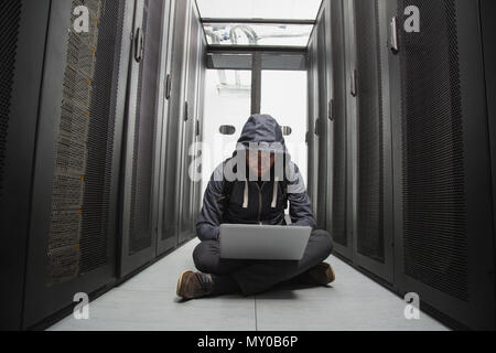 Focused male hacker cracking software Stock Photo
