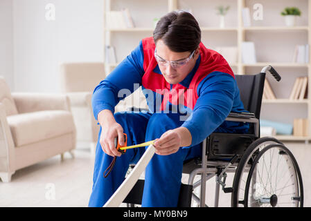 Disabled man repairing chair in workshop Stock Photo
