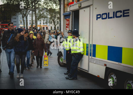 London, UK - October 2017. Policemen patrolling the crowded streets around Leicester Square, in central London. Landscape format. Stock Photo