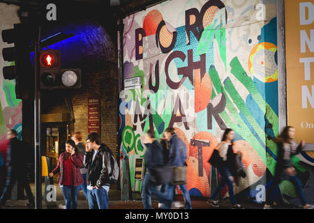 London, UK - November 2017. Tourists and shoppers in Borough Market, one of the largest and oldest food markets in London. Landscape format. Stock Photo