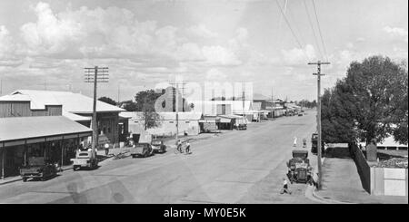 Shamrock Street, Blackall, March 1938. From the Western Star and Roma Advertiser, Saturday 24 January 1925:  Sensation at Blackall. 98035362?searchTerm=shamrock street blackall&amp;searchLimits=l-state=Queensland )   BULLOCK RUNS AMOK.  On Thursday afternoon last, the 15th inst., a young bullock made his appearance in the main street near the State School (says Barcoo Independent). He had been worried by dogs, and was looking for gore. Miss Langland and some children had a narrow escape from him, and the bullock then went into Burney's allotment. Ranger Sheehan tried to get him out, but the bu Stock Photo