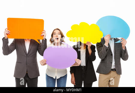 Portrait of a group of excited business people holding empty speech bubbles isolated over white background Stock Photo