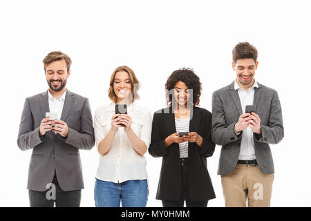 Group of smiling young business people using mobile phones isolated over white background Stock Photo