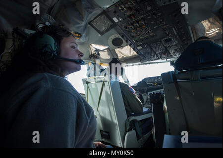 Emily Willhide, Team Shaw spouse, takes in the view from the cockpit of a KC-135 Stratotanker during a collaborative refueling training and spouse flight event at Shaw Air Force Base, S.C., Dec. 21, 2016. Airmen from the 93rd Air Refueling Squadron at Fairchild Air Force Base, Wash., brought the KC-135 to Shaw specifically for this training and utilized the ample space in both the cockpit and main cabin to take multiple Team Shaw spouses on a single spouse flight. (U.S. Air Force photo by Senior Airman Zade Vadnais) Stock Photo