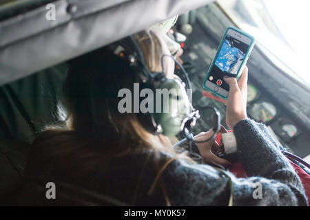 Sandra Vanta, a Team Shaw spouse, takes photos of her husband, Maj. Jason Vanta, 77th Fighter Squadron F-16CM Fighting Falcon pilot, as he refuels his jet from a KC-135 Stratotanker assigned to the 93rd Air Refueling Squadron from Fairchild Air Force Base, Wash., during a collaborative refueling training and spouse flight event over the Atlantic Ocean, Dec. 21, 2016. During the event, Team Shaw pilots were able to practice refueling procedures and their spouses were able to get a closer look at the job their husbands do every day. (U.S. Air Force photo by Senior Airman Zade Vadnais) Stock Photo