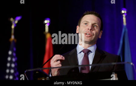 Historical photograph of CBP Commissioner Kevin K. McAleenan: U.S. Customs and Border Protection Deputy Commissioner Kevin K. McAleenan delivers the luncheon keynote at the 2016 East Coast Trade Symposium in Crystal City, Va., December 2, 2016. U.S. Customs and Border Protection Photo by Glenn Fawcett Stock Photo