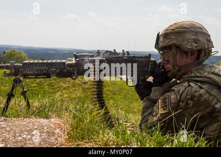 A soldier from the 709th Military Police Battalion zeros in on the target during the battalion's live fire exercise in preparation for Saber Strike 18. Stock Photo