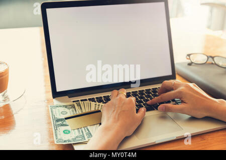 Woman using laptop to search web site for online shopping. Stock Photo