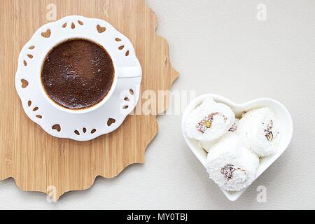 Turkish coffee with milk cream chocolate pistachio flavored white Turkish delight background Stock Photo