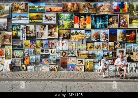 Krakow, Poland. 4th June, 2018. Two painters are seen as they wait to sell theirs paintings in Krakow.Krakow is a the second largest city in Poland and it is located in the southern part of the country. Credit: Omar Marques/SOPA Images/ZUMA Wire/Alamy Live News Stock Photo