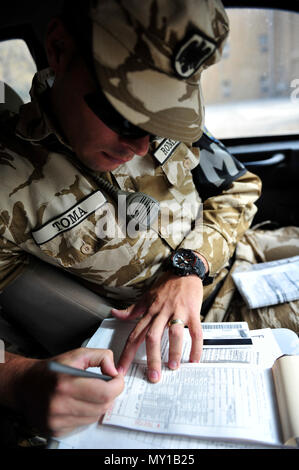 Cpl Caporal Marius Toma Writes A Traffic Citation For A Driver On Disney Drive On Bagram