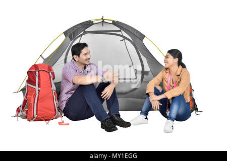 Portrait of asian couple discussion in front of tent isolated over white background Stock Photo