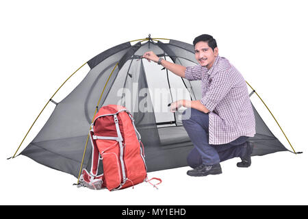 Portrait of asian backpacker man prepare the tent posing isolated over white background Stock Photo