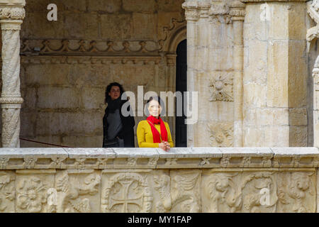 LISBON, PORTUGAL- APRIL 4, 2018: Unidentified asiatic woman stands and observes the majestic Jeronimos monastery in Lisbon, Portugal Stock Photo