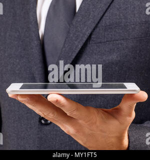 Businessman holds digital tablet. Close-up shot. Stock Photo
