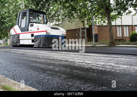Work on the laying of asphalt in the city. Pneumatic Tire Roller machine at work Stock Photo