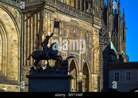 Statue of Saint George with St. Vitus Cathedral Golden Gate in the background Stock Photo