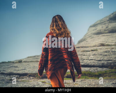 A young woman is walking in the fog on a moor Stock Photo