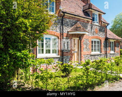 A typical brick and flint country cottage in Wiltshire. Stock Photo