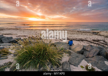 Couple on the beach at sunset, West Fjords, Iceland Stock Photo