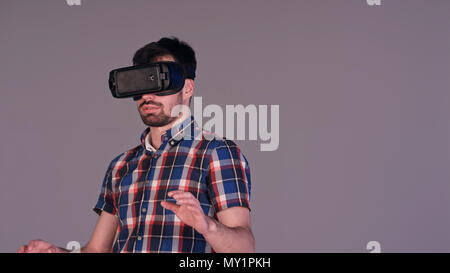 Young man working in virtual reality glasses Stock Photo